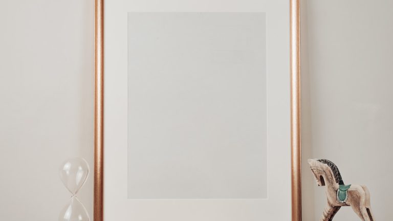 white wooden framed mirror on brown wooden table